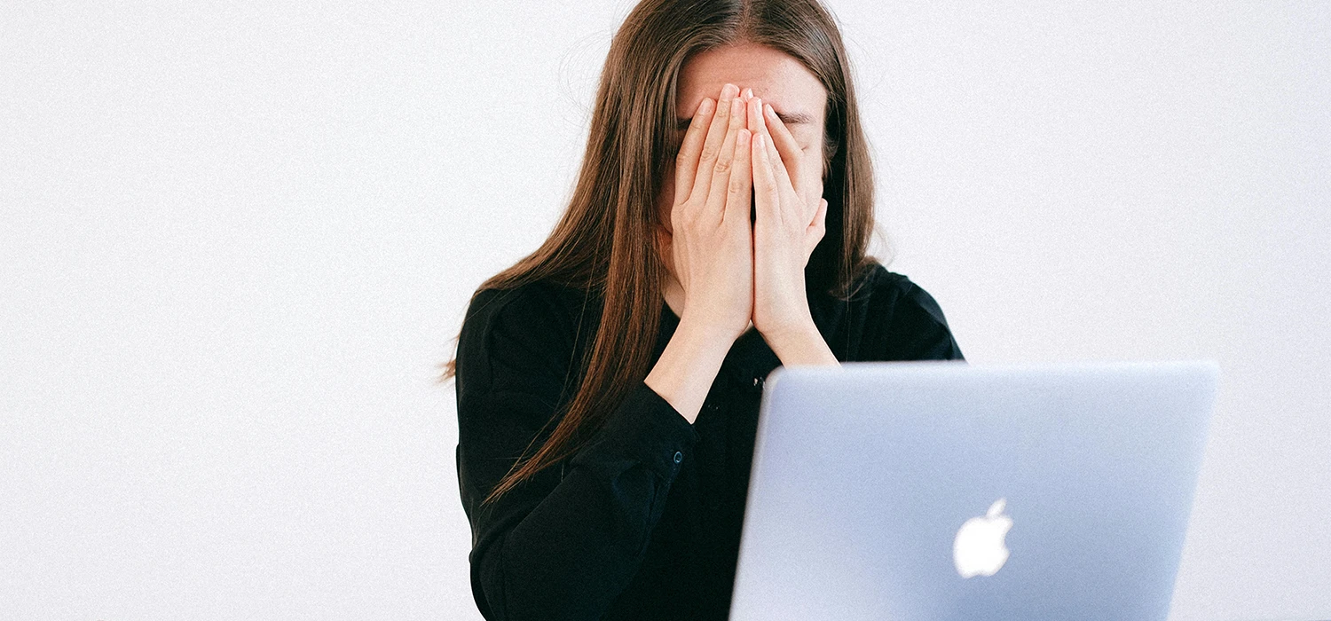 Femme exaspérée devant un ordinateur portable